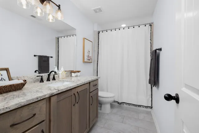 a living room with furniture and book shelf