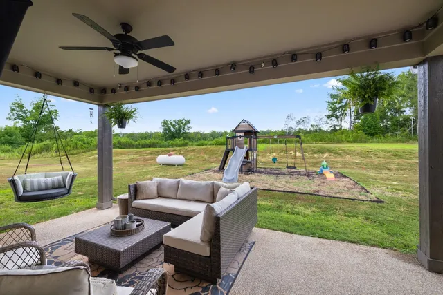 a bathroom with a granite countertop sink a toilet and a mirror