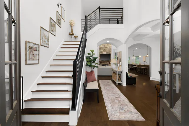 a view of entryway and hall with wooden floor