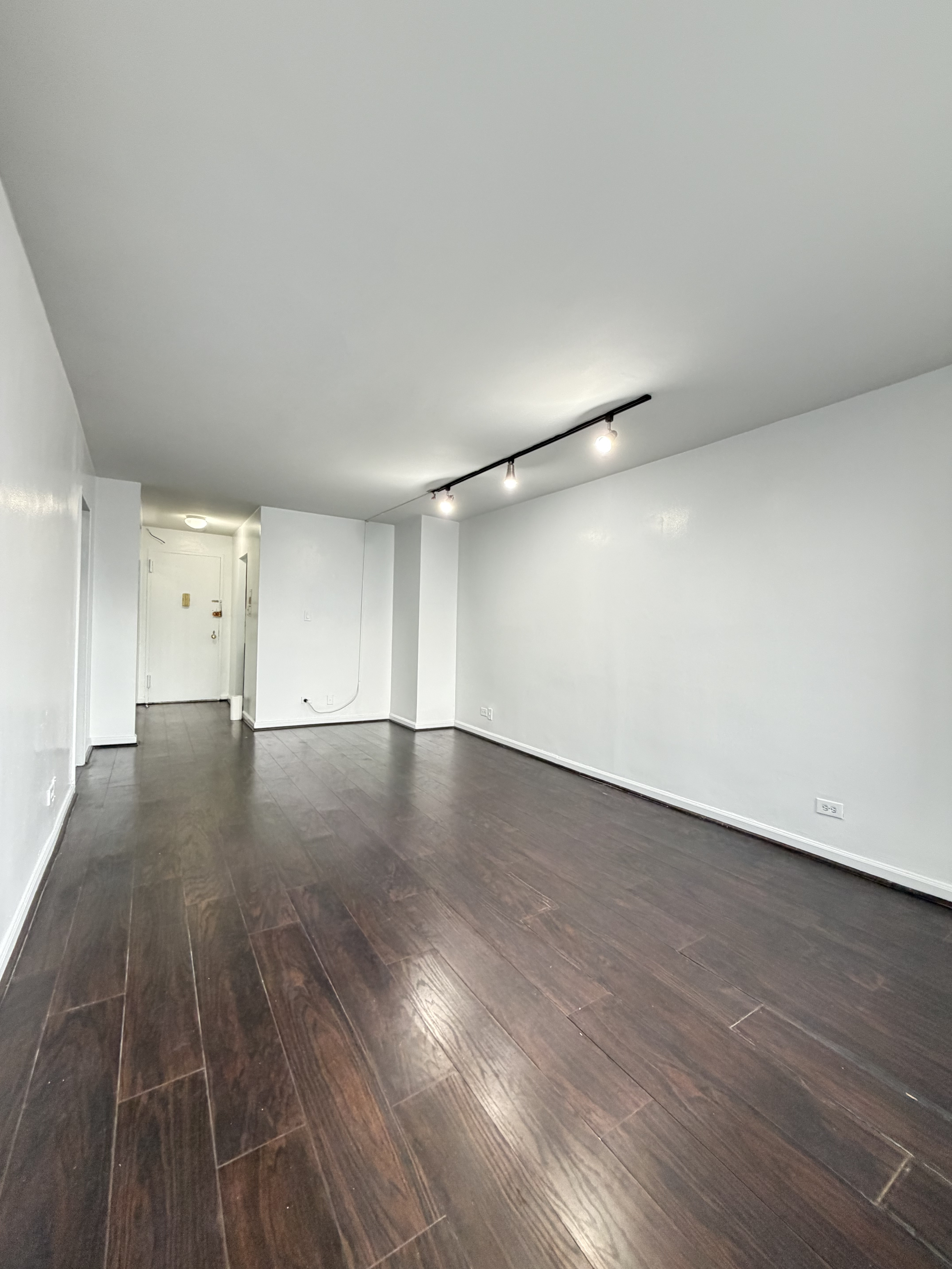85-15 Main Street, Unit 2R Queens, NY 11435 - Photo 11 of 15 a view of a room with wooden floor and white walls