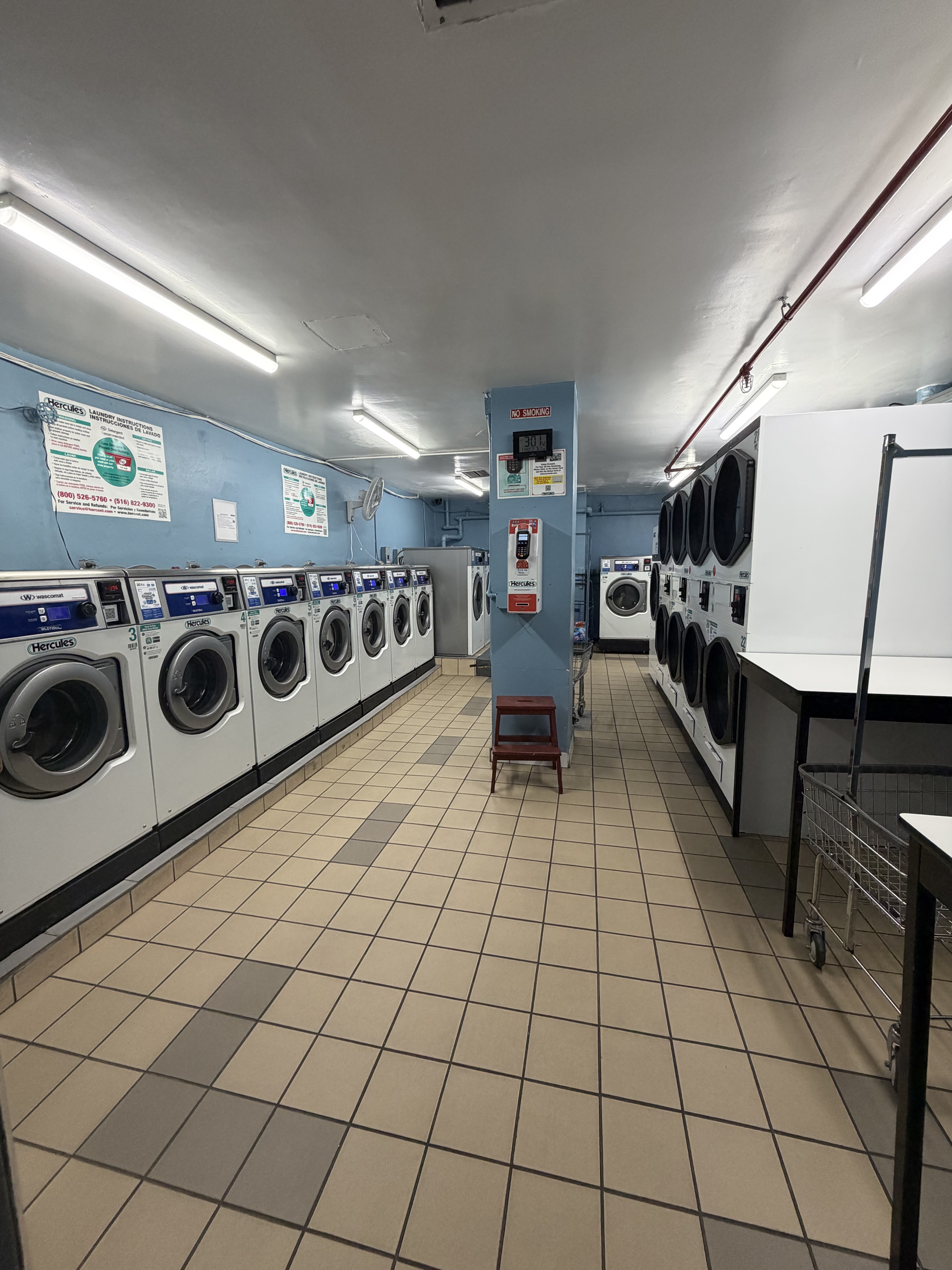85-15 Main Street, Unit 2R Queens, NY 11435 - Photo 13 of 15 a kitchen with stainless steel appliances granite countertop a stove a sink and a microwave