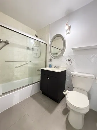 a bathroom with a toilet a sink and a mirror