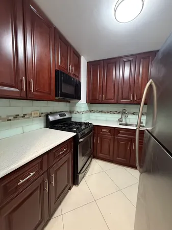a kitchen with a sink and a stove top oven