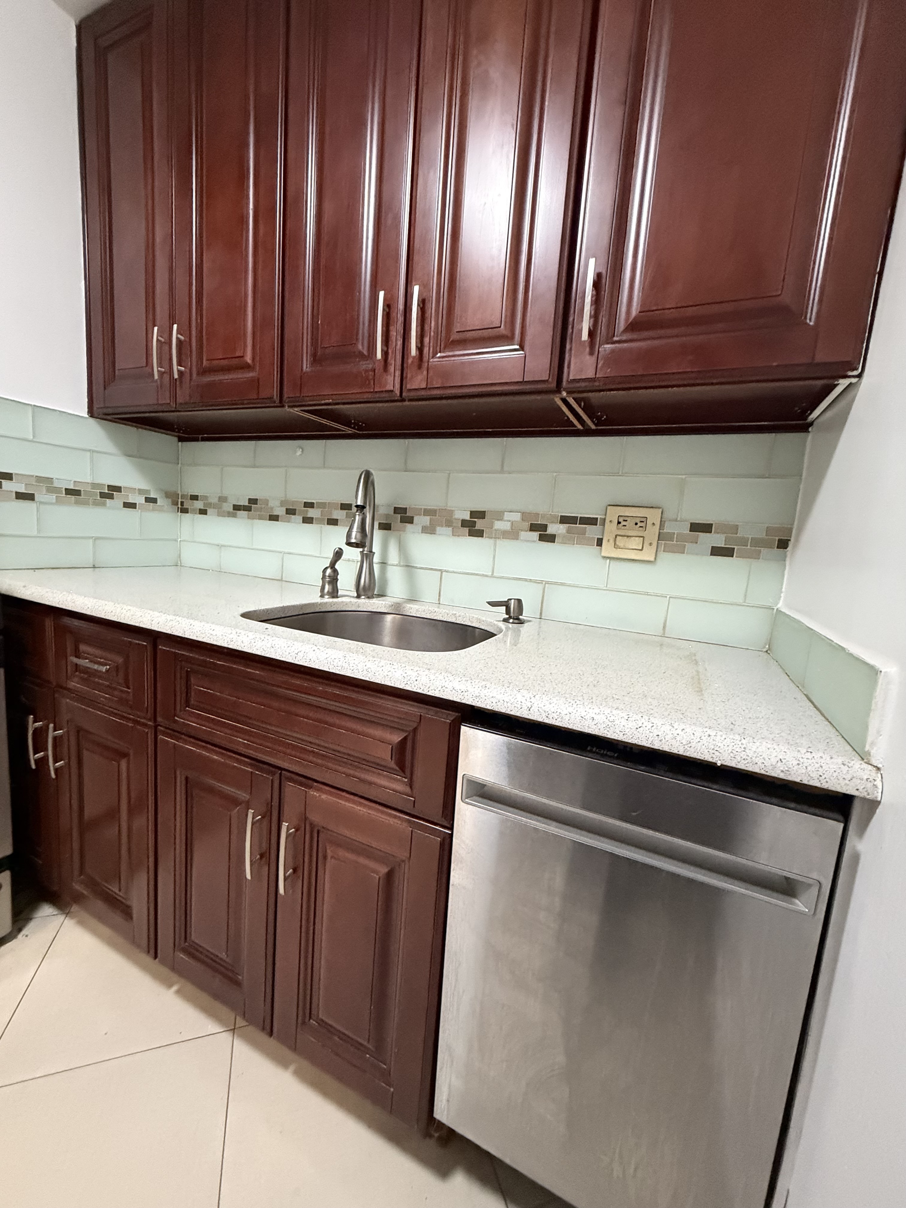 85-15 Main Street, Unit 2R Queens, NY 11435 - Photo 7 of 15 a kitchen with a sink and cabinets