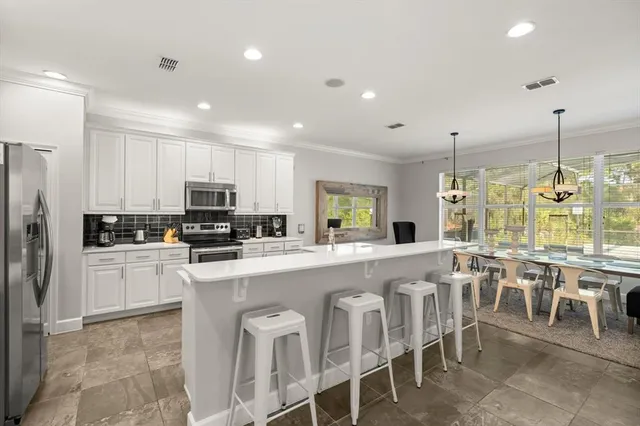 a kitchen with appliances a sink a counter top space and appliances