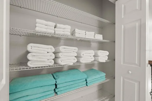 a living room with a flat screen tv and white walls