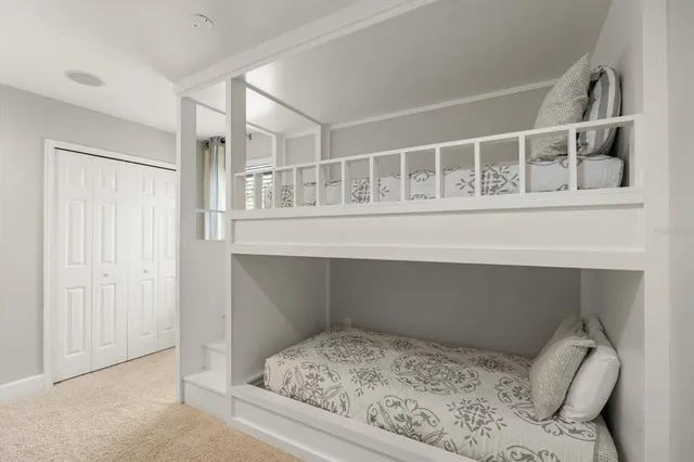 a bedroom with a large bed and a window