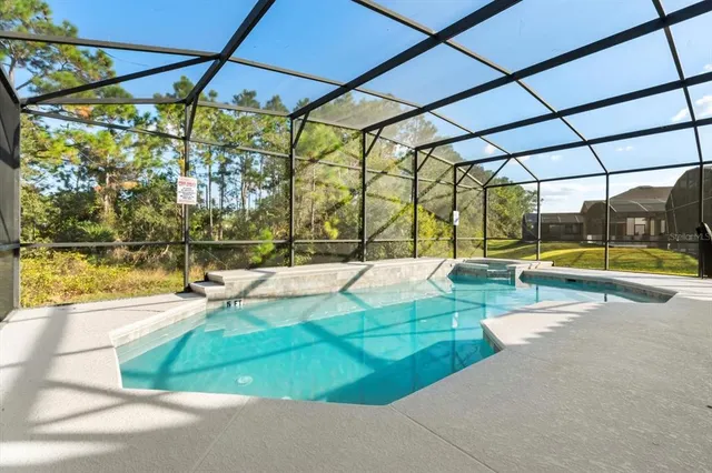 an aerial view of a house with a swimming pool