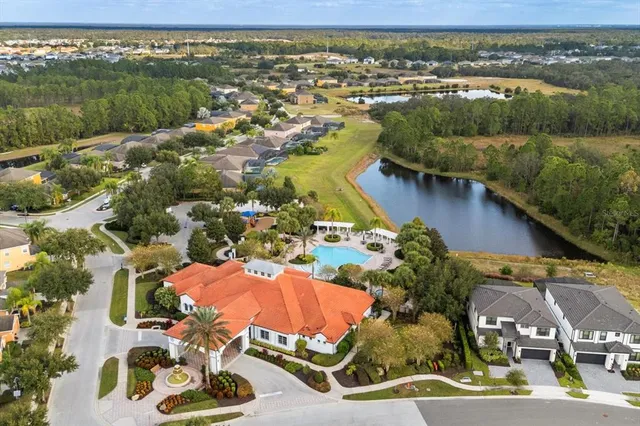 an aerial view of a house with backyard and deck