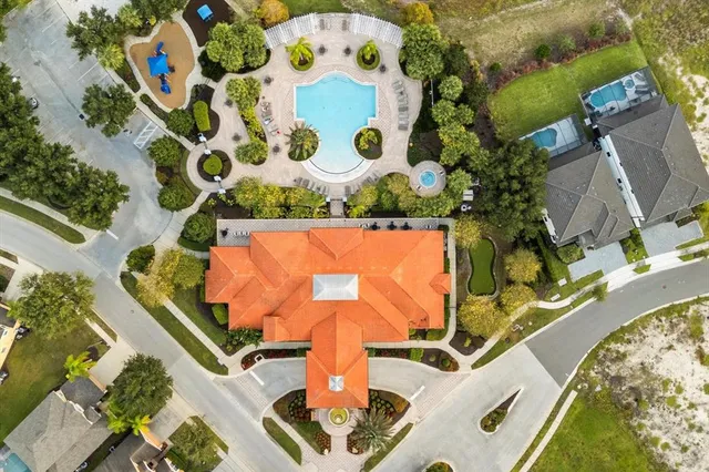 an aerial view of residential houses with outdoor space and river