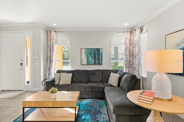 a living room with furniture and a large window