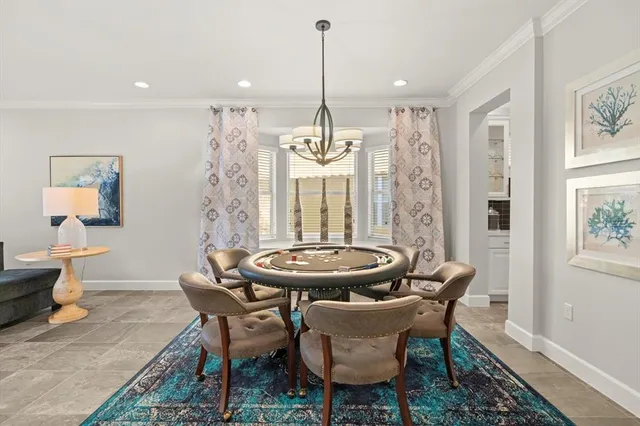 a dining room with furniture a chandelier and wooden floor