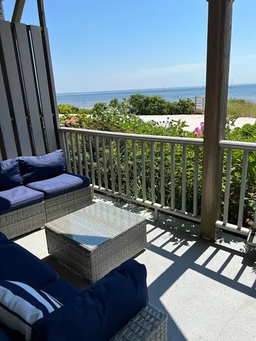 a room with furniture and a floor to ceiling window