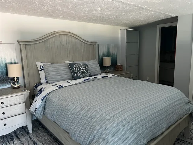 a bedroom with a bed and a mirror