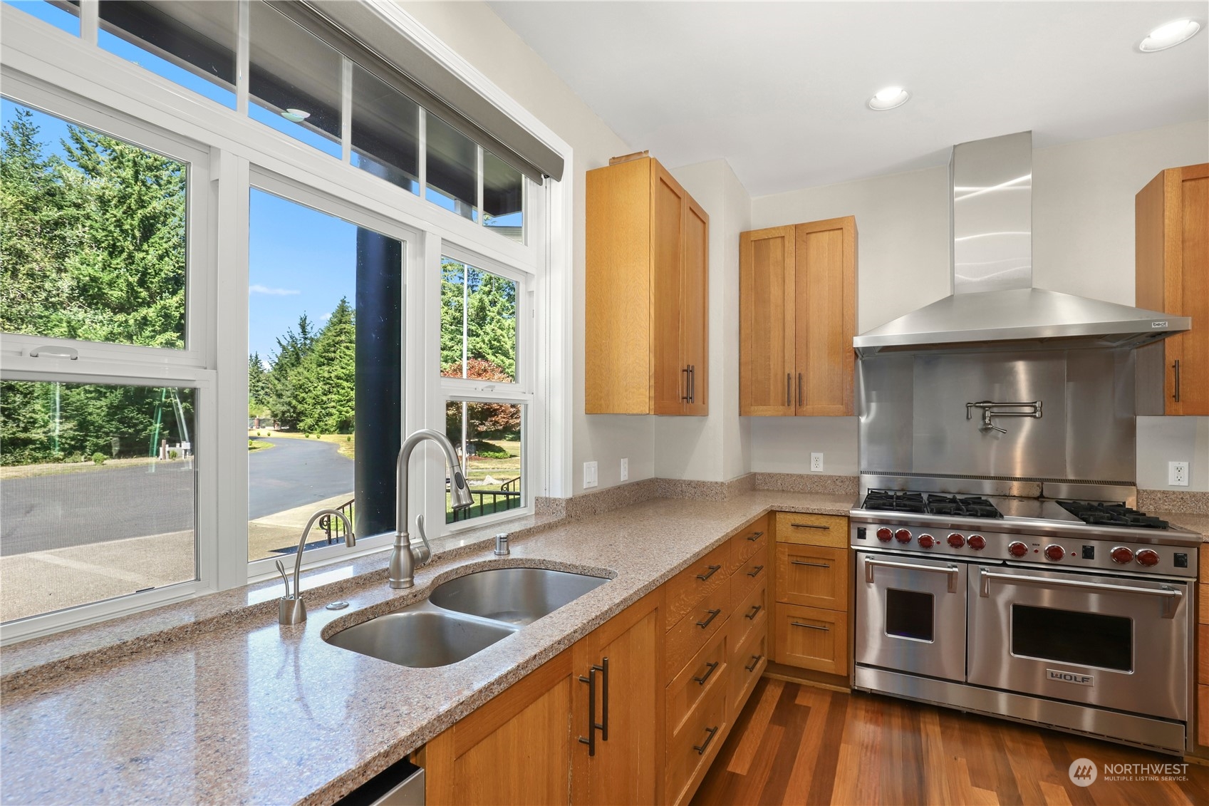 9109 Rich Road Southeast Olympia, WA 98501 - Photo 11 of 40 a kitchen with stainless steel appliances granite countertop a sink a stove and a wooden cabinets