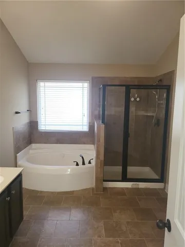 a bathroom with a bathtub and shower