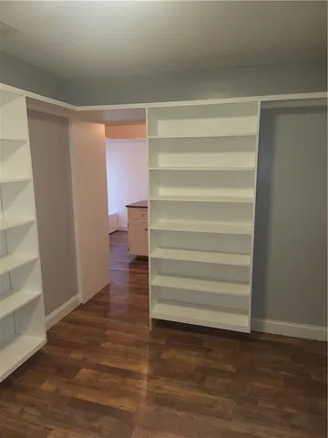 a view of walk in closet with empty racks