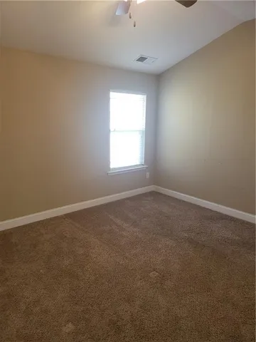 a bathroom with a granite countertop sink and white cabinets