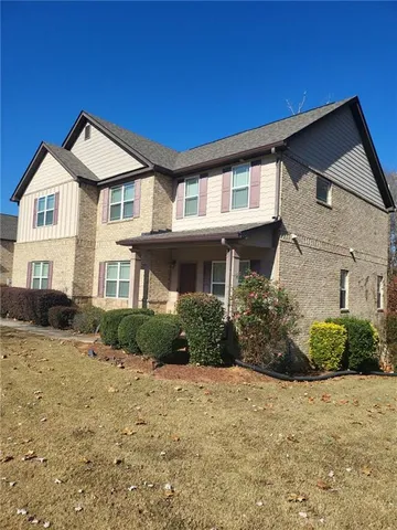 a front view of a house with a yard