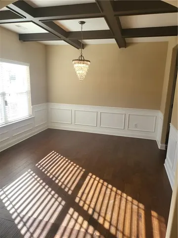 a view of a room with an empty space and a window