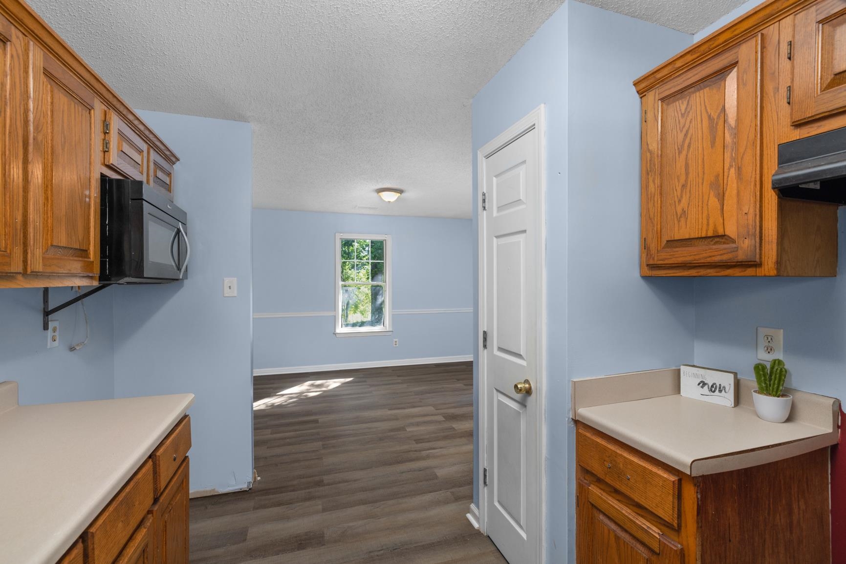 366 Adkins Road Burlison, TN 38015 - Photo 8 of 20 Kitchen area featuring wood cabinetry, a built-in microwave, and light-toned countertops