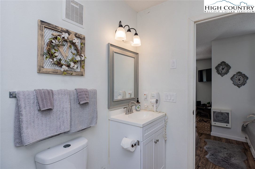301 Pinnacle Inn Road, Unit 4305 Beech Mountain, NC 28604 - Photo 24 of 49 a bathroom with a sink and mirror with toilet