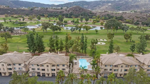 an aerial view of residential houses with outdoor space and river