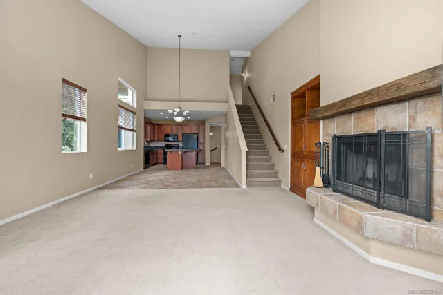 a view of a livingroom with furniture and staircase