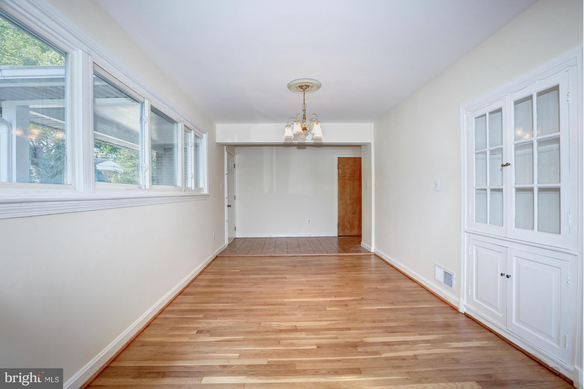 10123 Renfrew Road Silver Spring, MD 20901 - Photo 3 of 18 a view of an empty room with wooden floor and a window