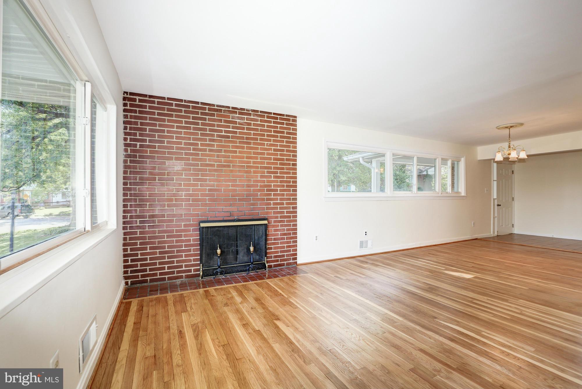 10123 Renfrew Road Silver Spring, MD 20901 - Photo 5 of 18 a view of empty room with wooden floor and fireplace
