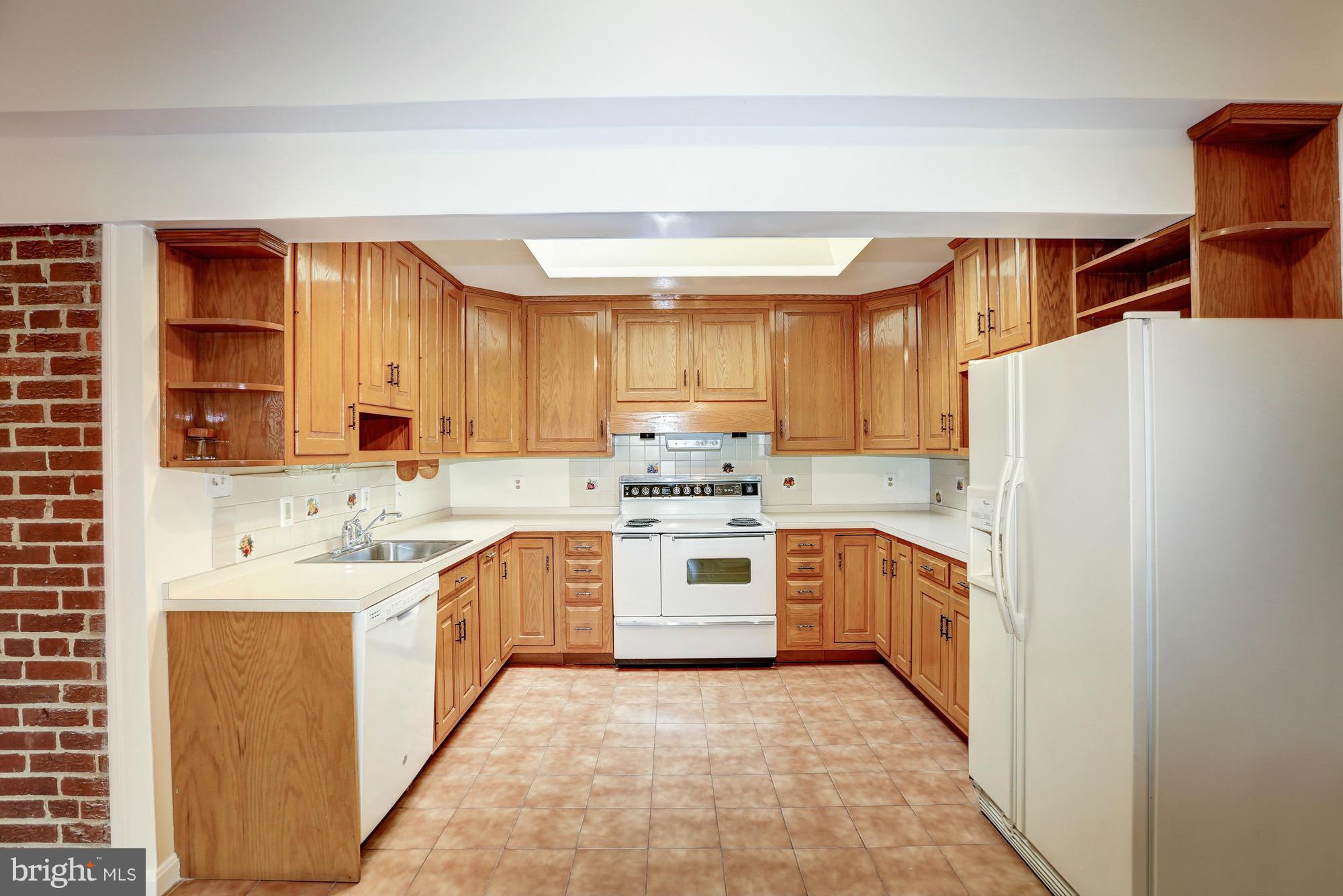10123 Renfrew Road Silver Spring, MD 20901 - Photo 7 of 18 a kitchen with white cabinets and white appliances