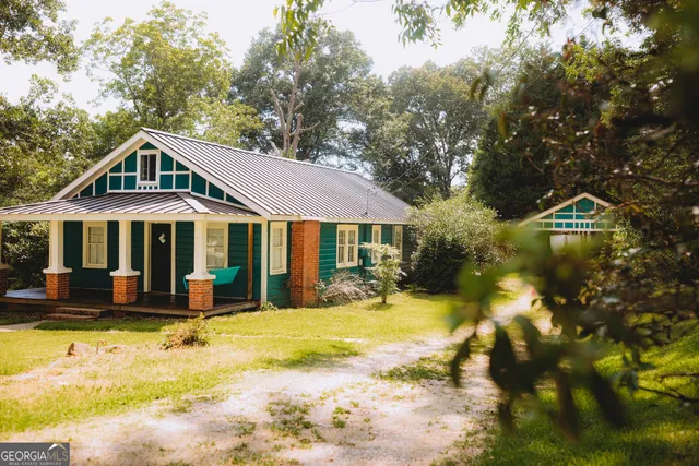 a front view of a house with a yard patio and swimming pool