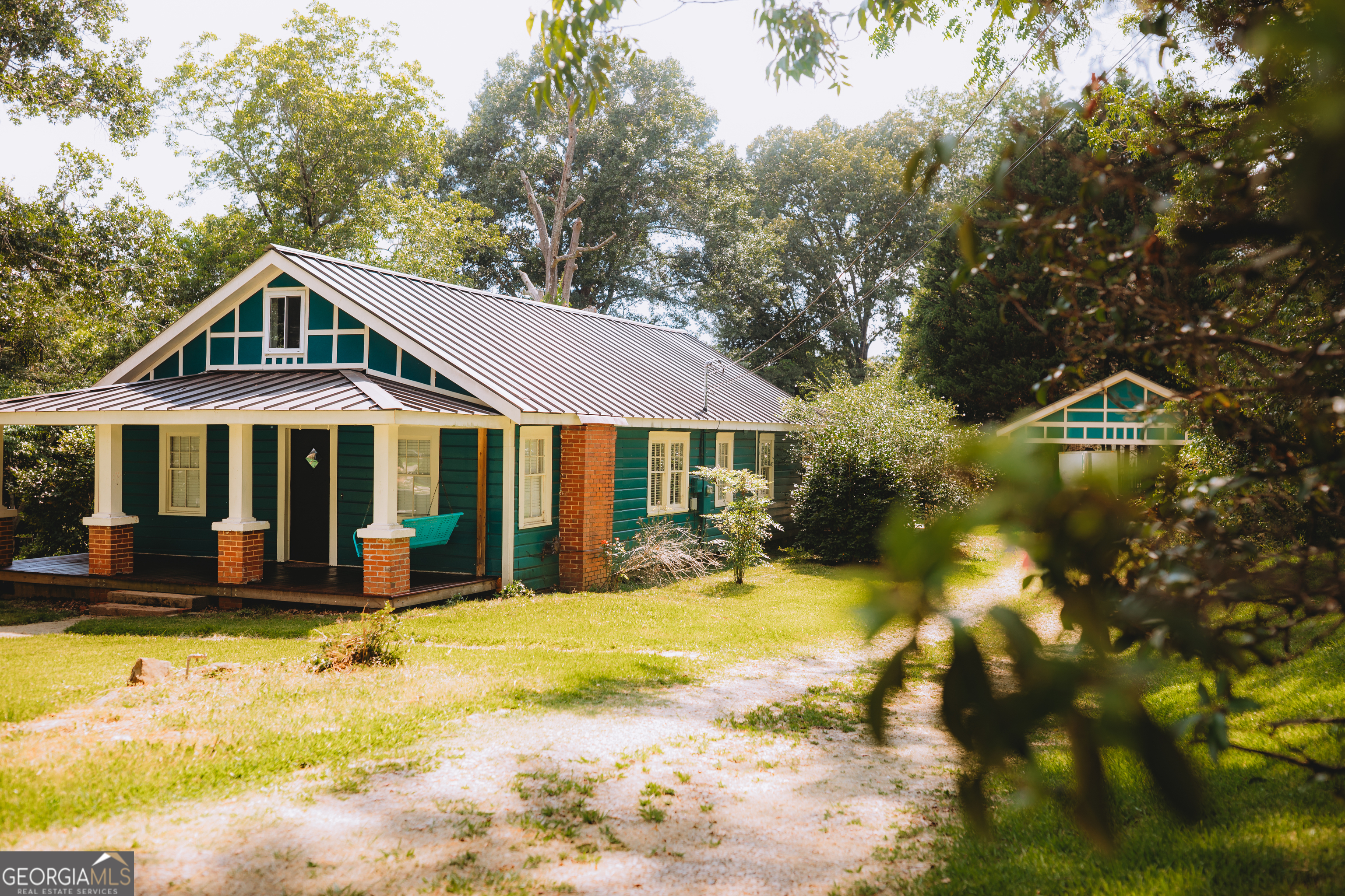 a front view of a house with a yard patio and swimming pool