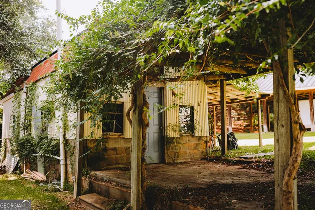 a spacious bedroom with a bed and dresser with wooden floor