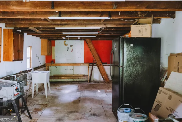 a bedroom with a bed and with view of living room