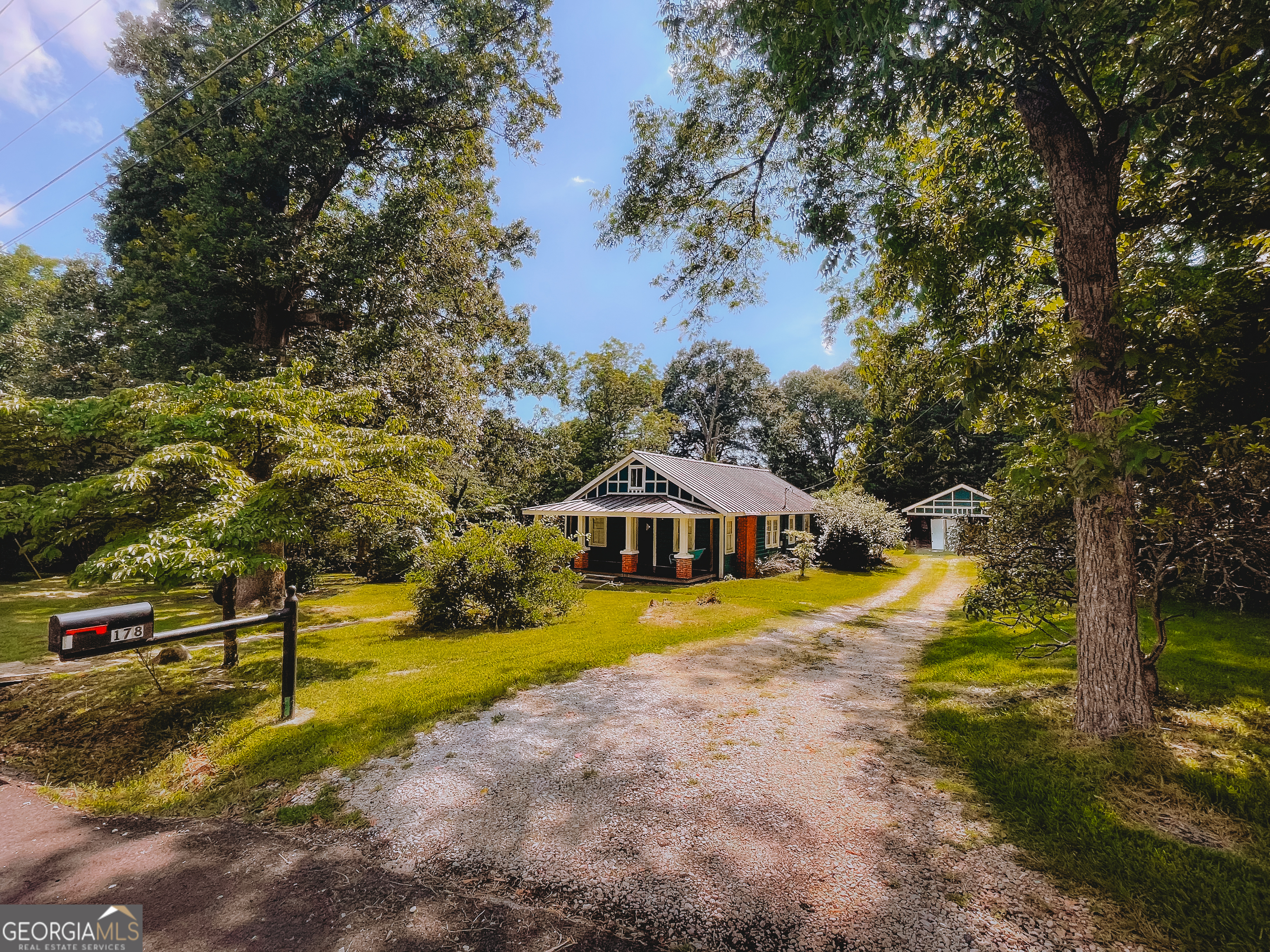 178 Mitchell Street Toccoa, GA 30577 - Photo 2 of 70 a view of swimming pool with large trees and wooden fence