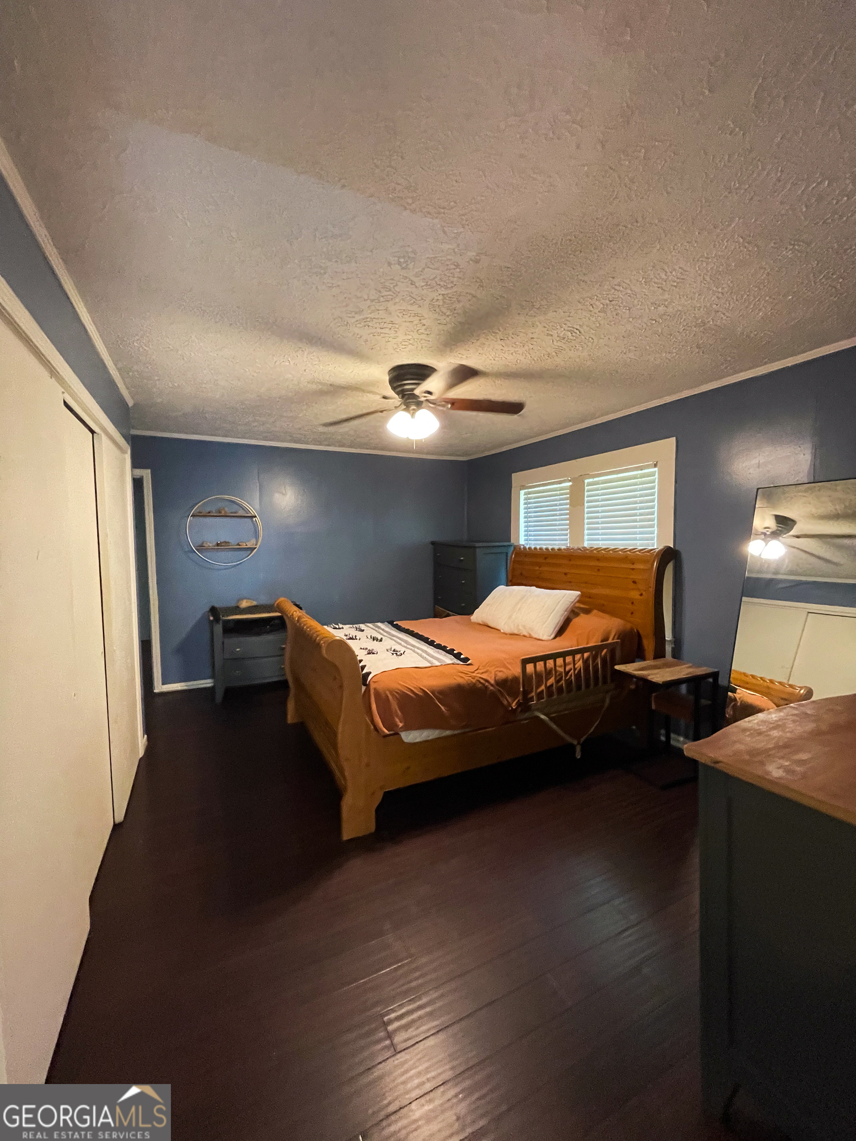 178 Mitchell Street Toccoa, GA 30577 - Photo 29 of 70 a spacious bedroom with a bed and dresser with wooden floor