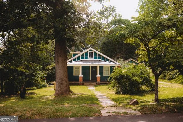 a front view of a house with swimming pool and porch
