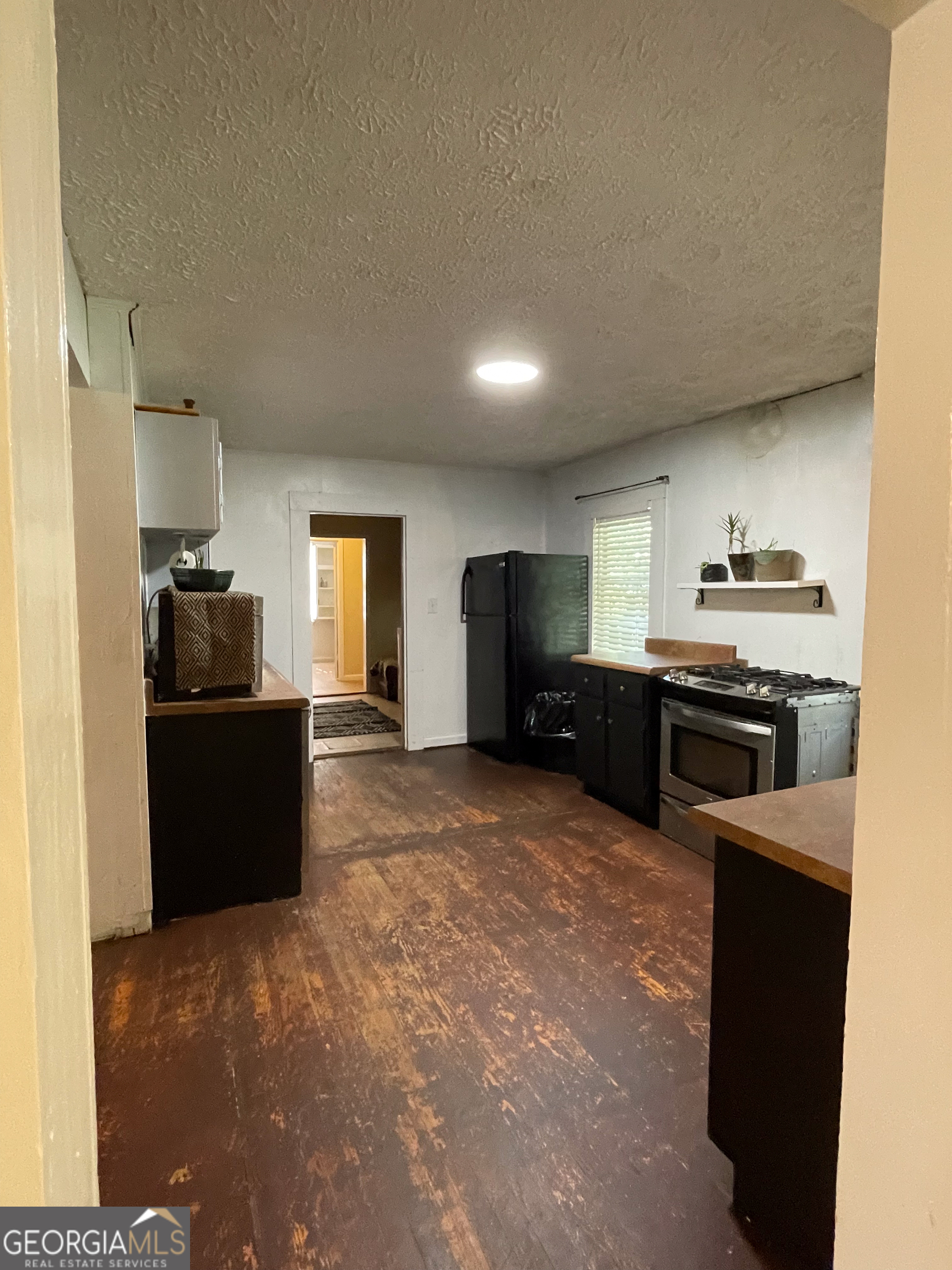 178 Mitchell Street Toccoa, GA 30577 - Photo 41 of 70 a kitchen with granite countertop a refrigerator and a stove top oven