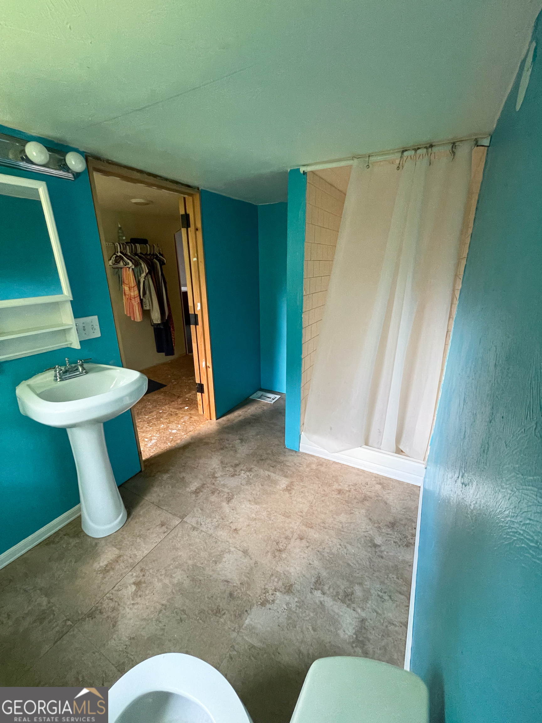 178 Mitchell Street Toccoa, GA 30577 - Photo 56 of 70 a view of a hallway with toilet and sink