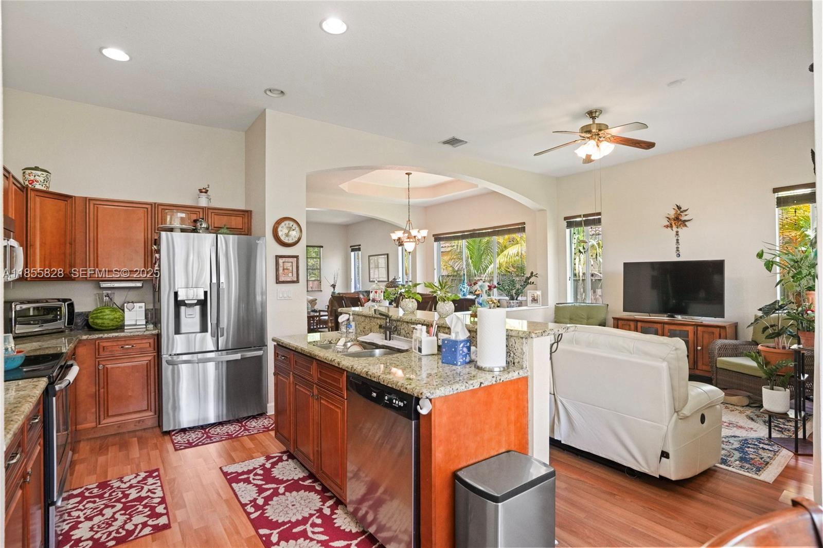9506 Southwest 220th Lane Cutler Bay, FL 33190 - Photo 13 of 51 a kitchen with stainless steel appliances granite countertop a stove refrigerator and chairs