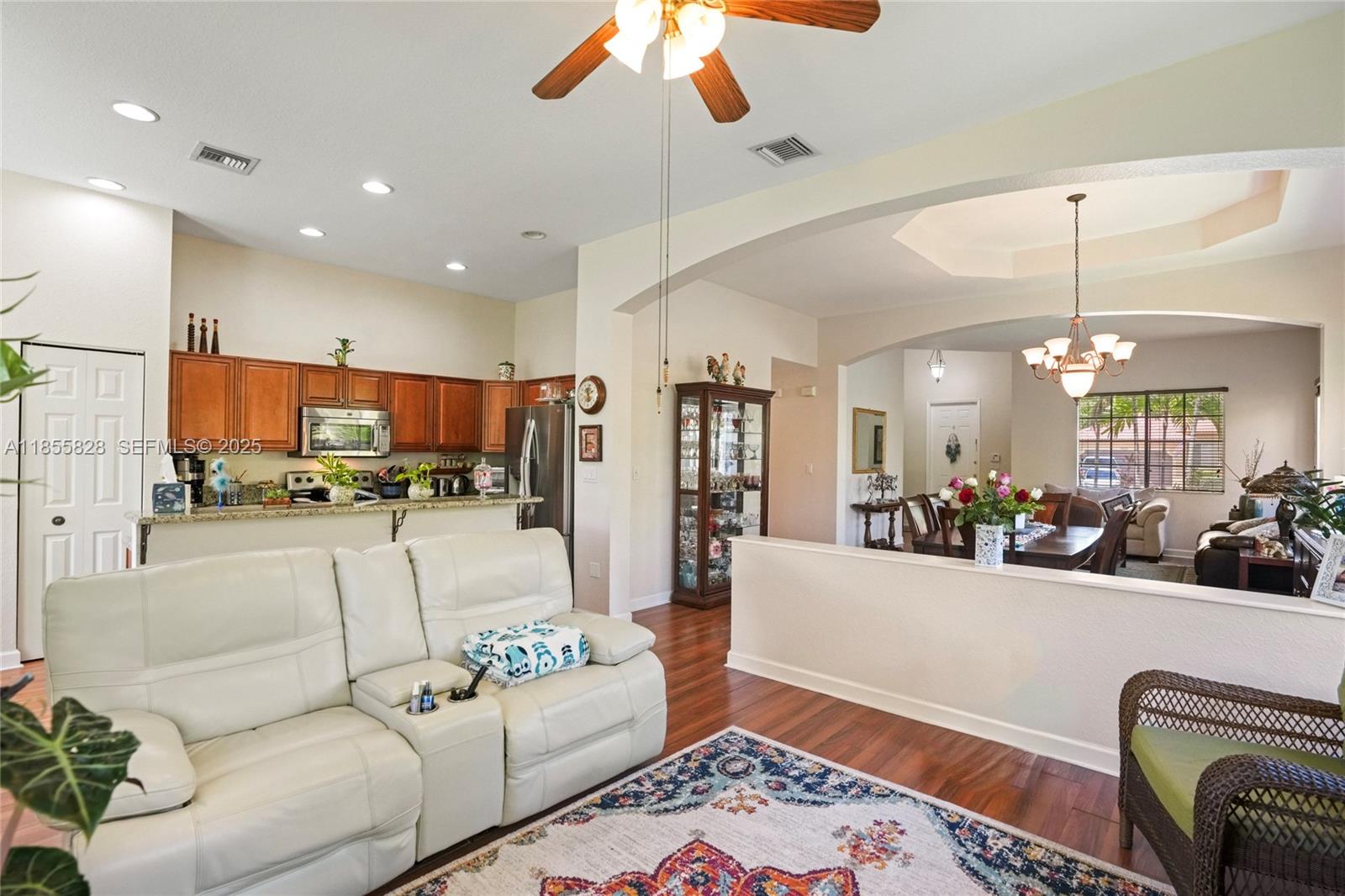9506 Southwest 220th Lane Cutler Bay, FL 33190 - Photo 20 of 51 a living room with furniture and a chandelier