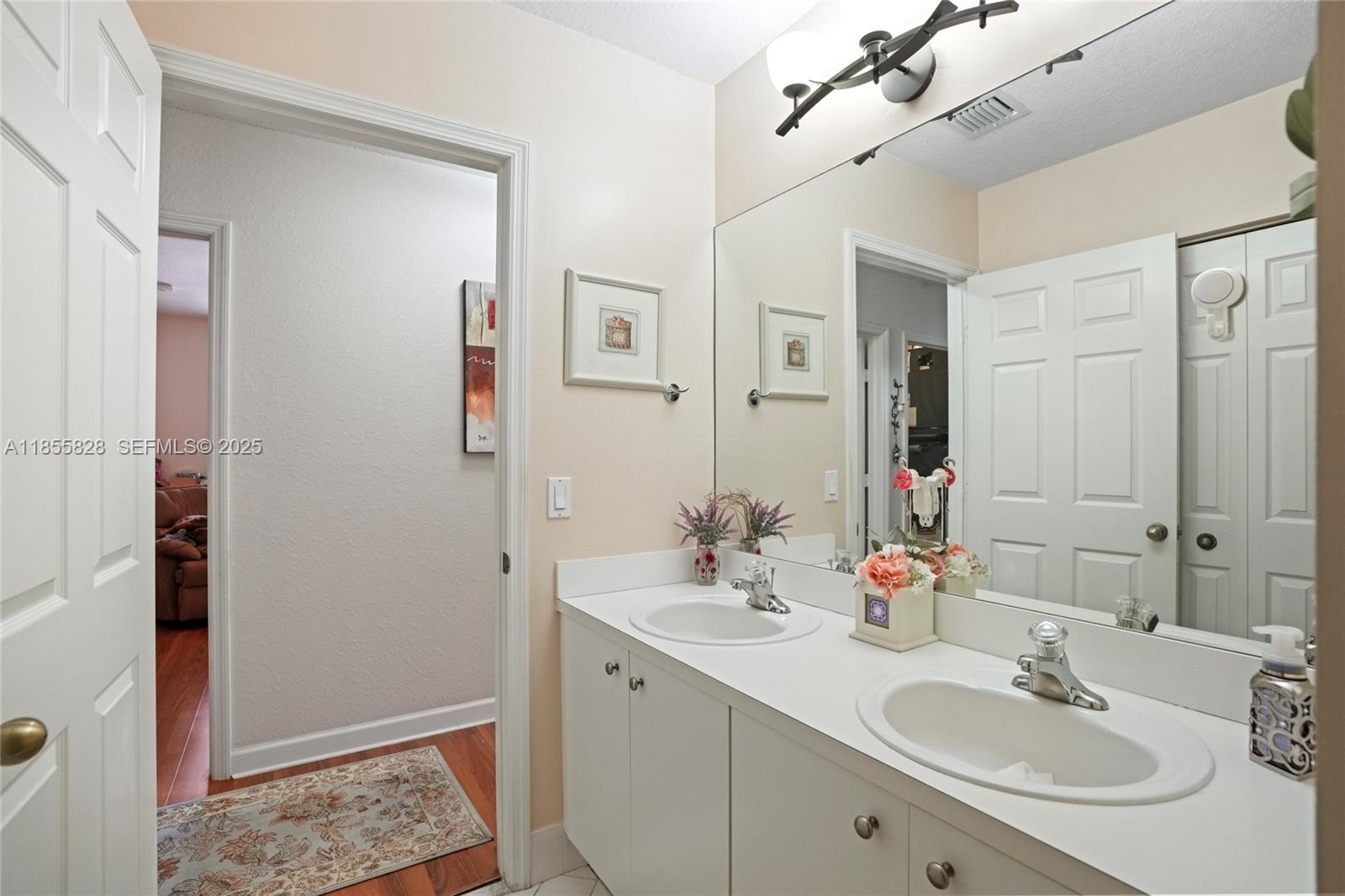 9506 Southwest 220th Lane Cutler Bay, FL 33190 - Photo 25 of 51 a bathroom with 2 sink and a mirror