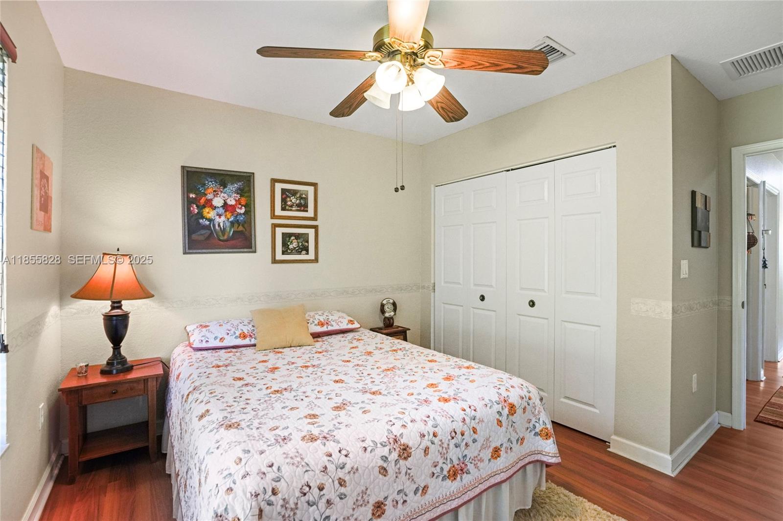 9506 Southwest 220th Lane Cutler Bay, FL 33190 - Photo 34 of 51 a bedroom with a bed and a chandelier