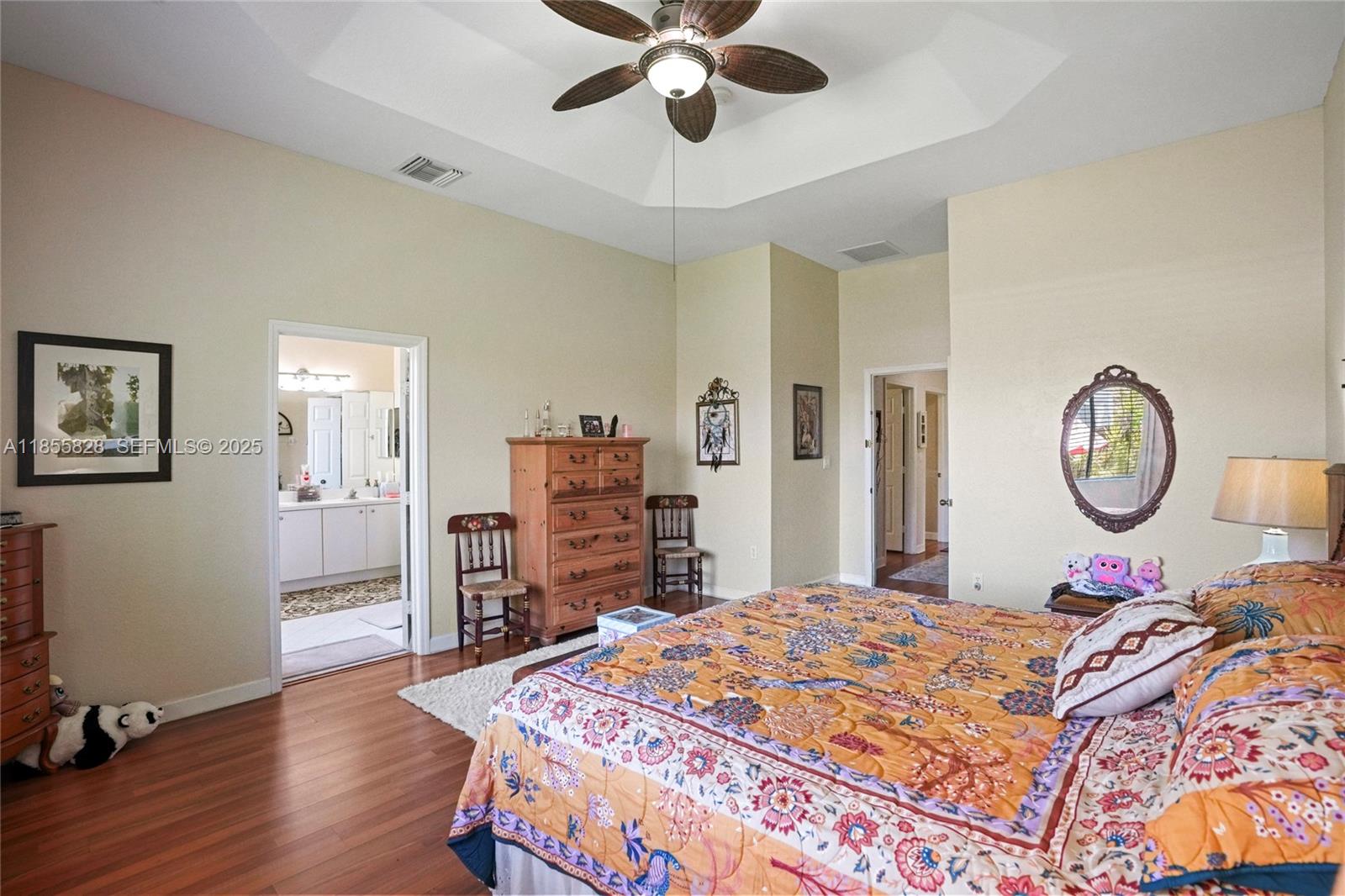 9506 Southwest 220th Lane Cutler Bay, FL 33190 - Photo 39 of 51 a bedroom with a bed and a chandelier