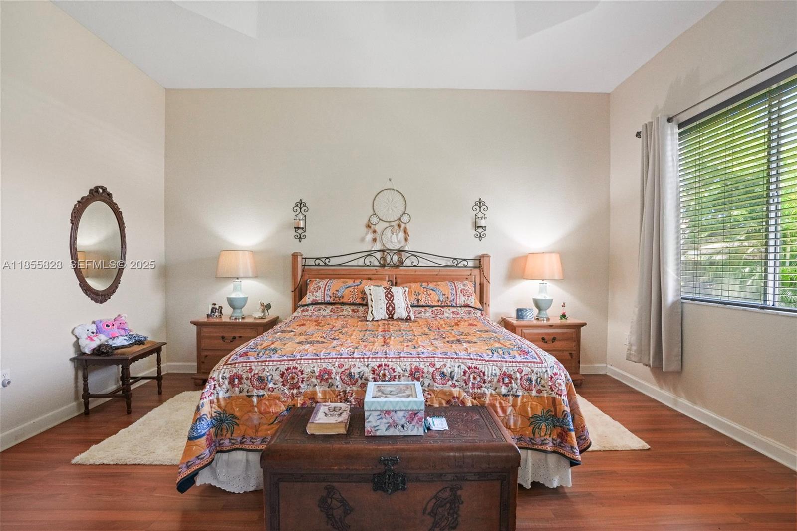 9506 Southwest 220th Lane Cutler Bay, FL 33190 - Photo 40 of 51 a bedroom with a bed a mirror and table