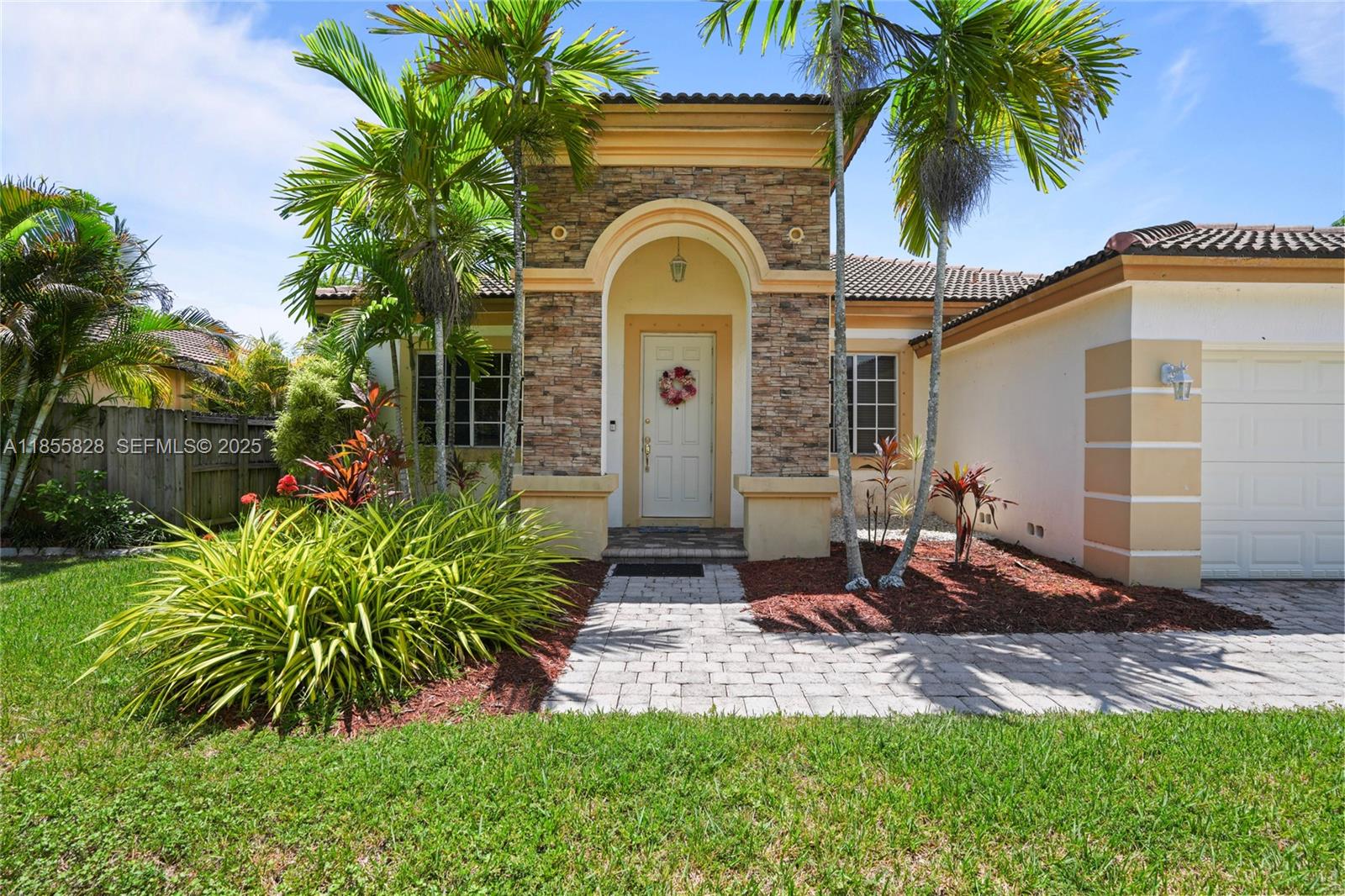 9506 Southwest 220th Lane Cutler Bay, FL 33190 - Photo 4 of 51 a front view of a house with garden