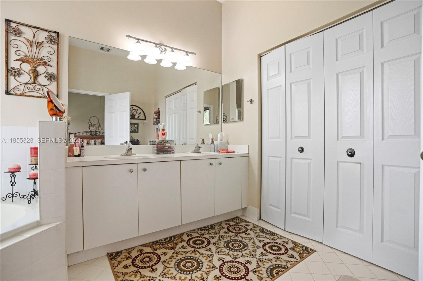 9506 Southwest 220th Lane Cutler Bay, FL 33190 - Photo 41 of 51 a bathroom with a sink and a mirror