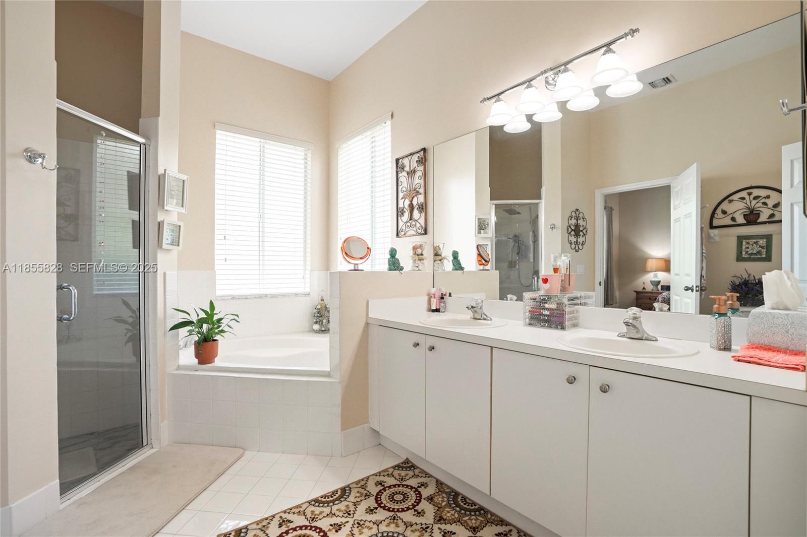 9506 Southwest 220th Lane Cutler Bay, FL 33190 - Photo 42 of 51 a bathroom with a double vanity sink and a mirror