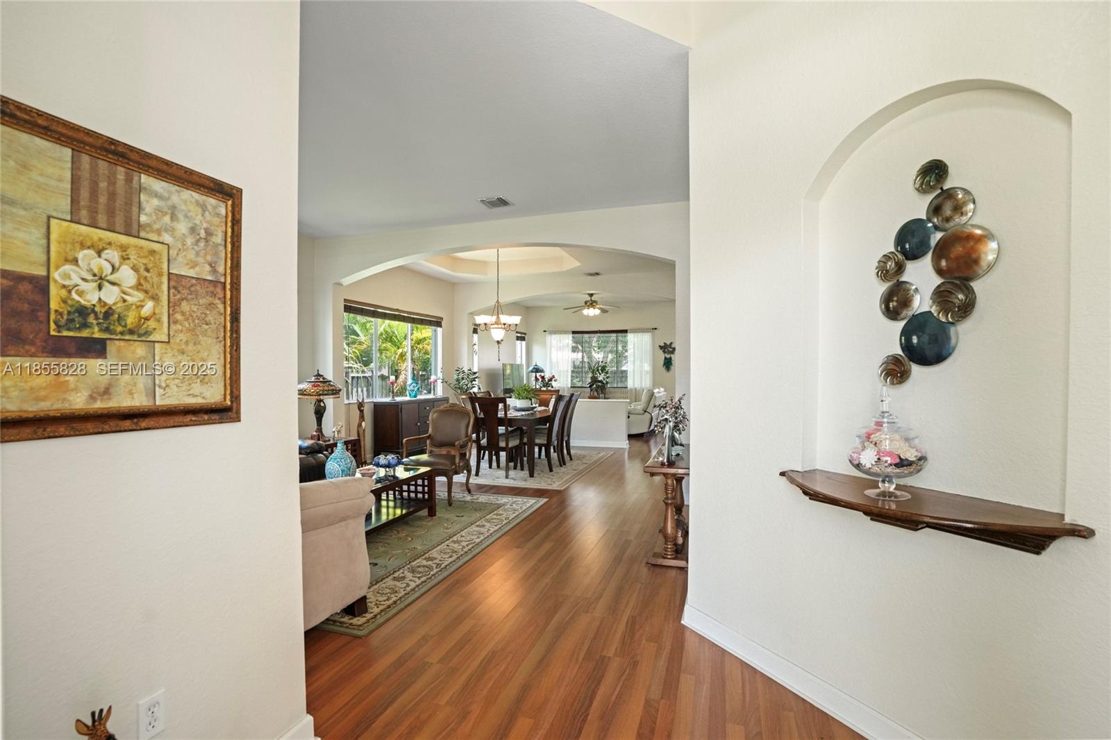 9506 Southwest 220th Lane Cutler Bay, FL 33190 - Photo 44 of 51 a view of a dining room with furniture one side kitchen view and wooden floor